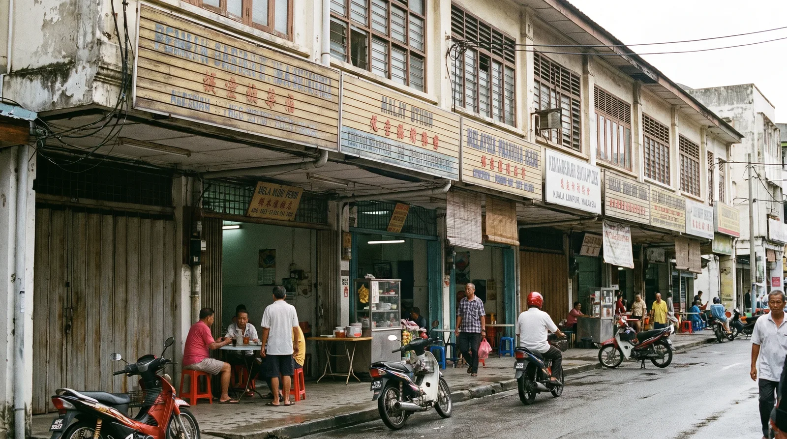 row of Malaysian shoplots with compliant horizontal fascia signboards above the covered walkway