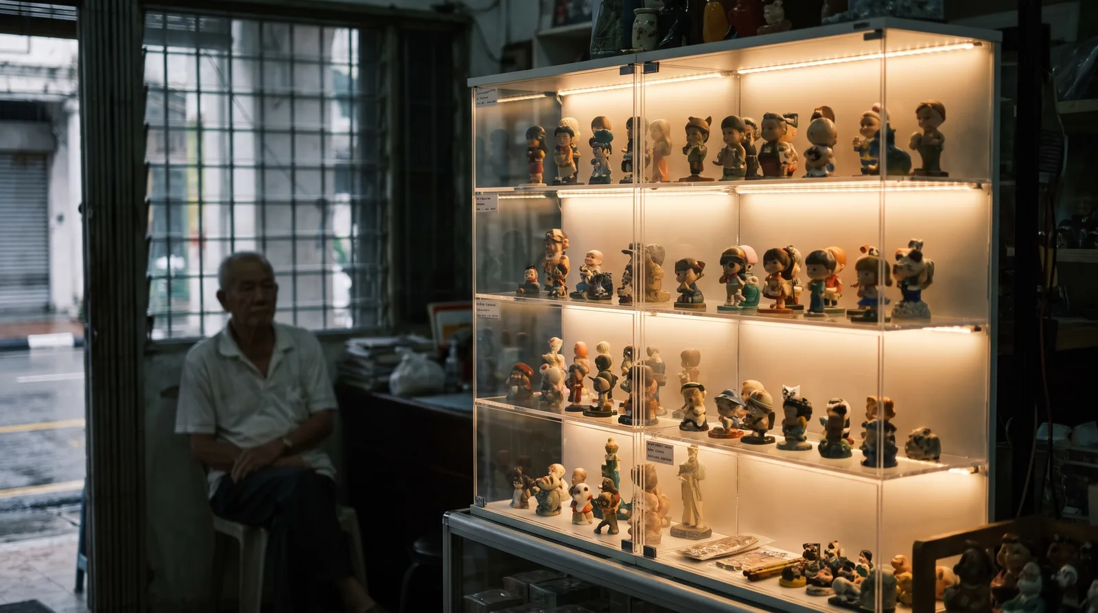 LED-lit acrylic display case glowing in a dim room, light washing evenly across the shelves