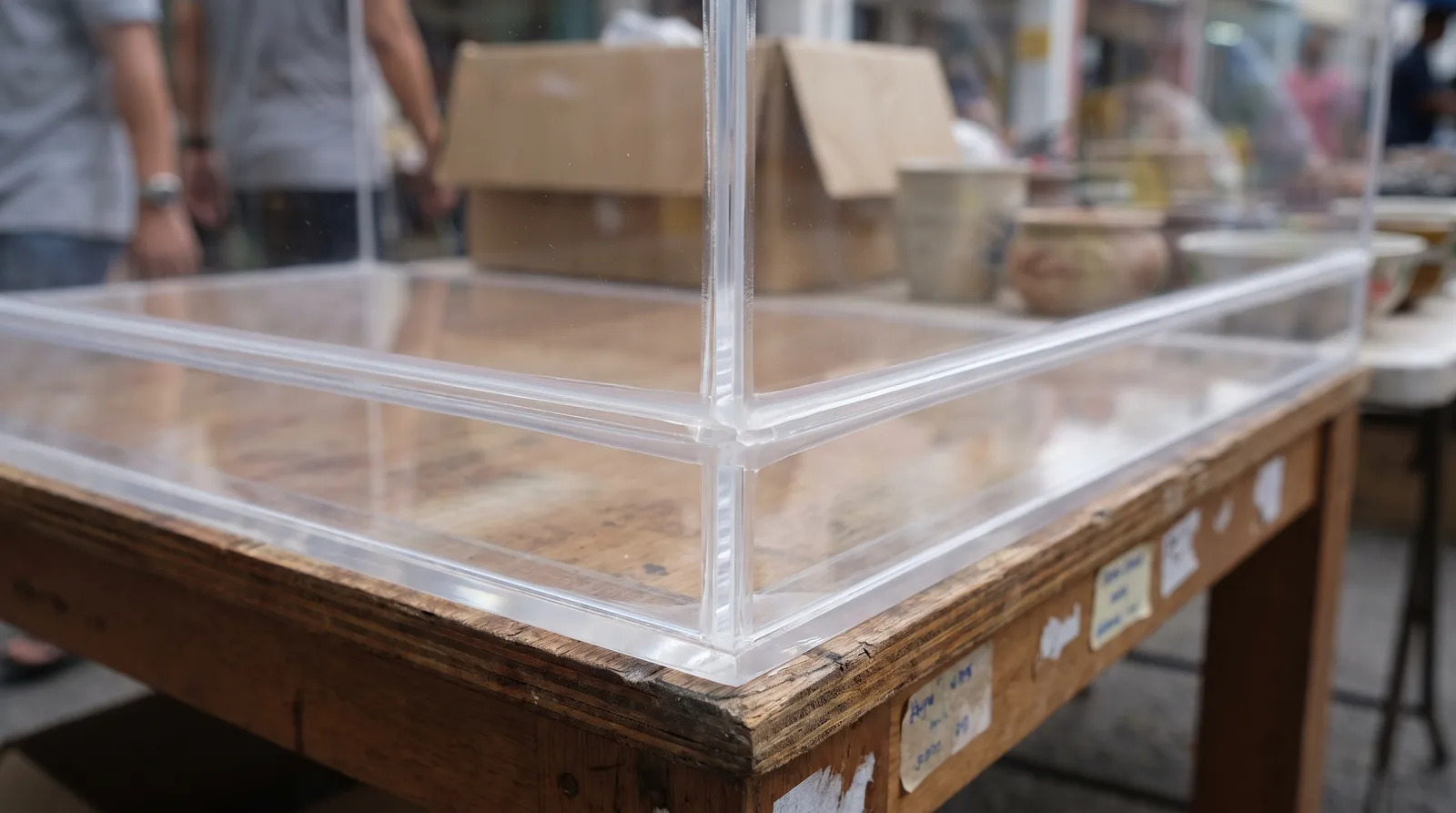 close-up of an acrylic display case corner joint, showing the clean polished edge and dust seal