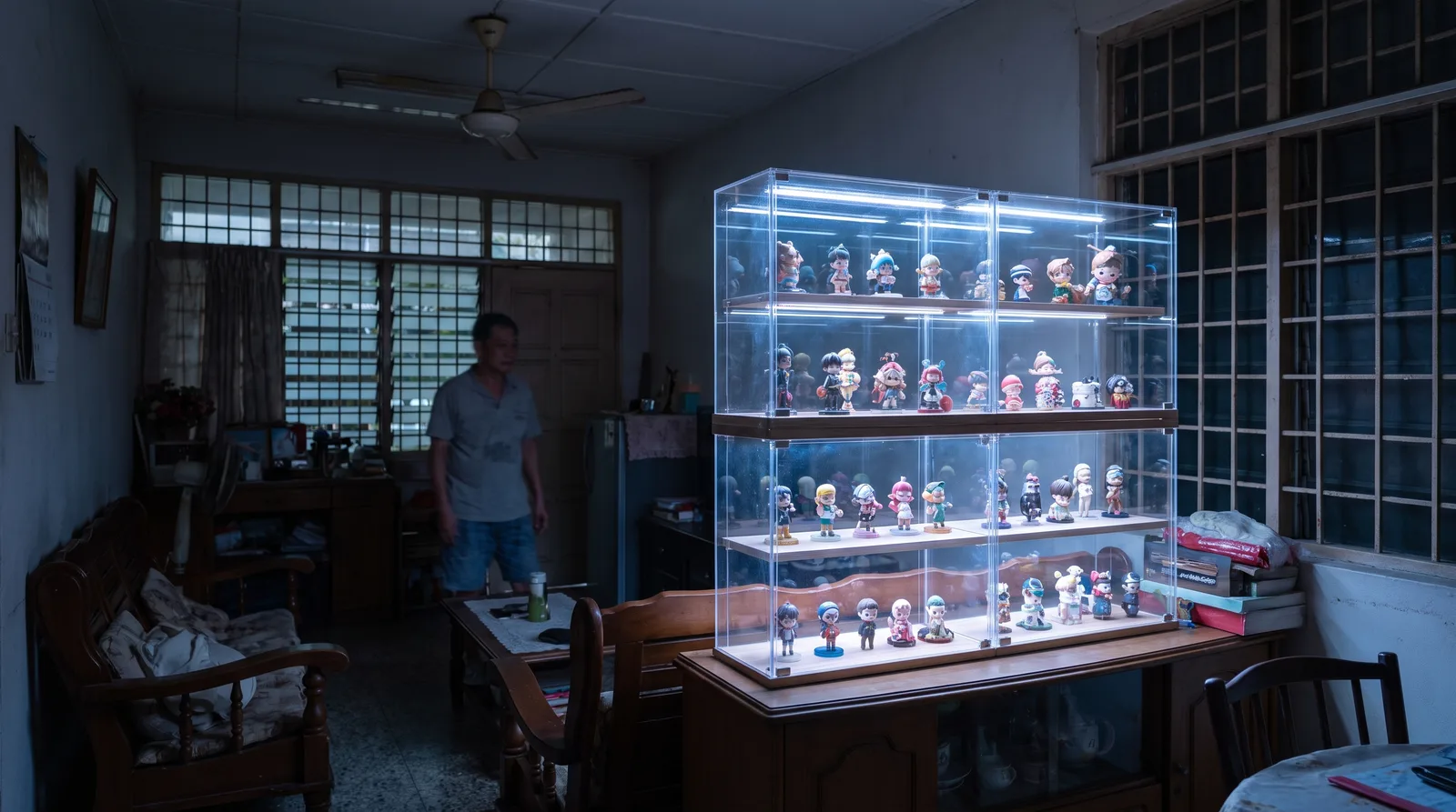 LED-lit acrylic display case glowing in a dim room, light washing evenly across the shelves