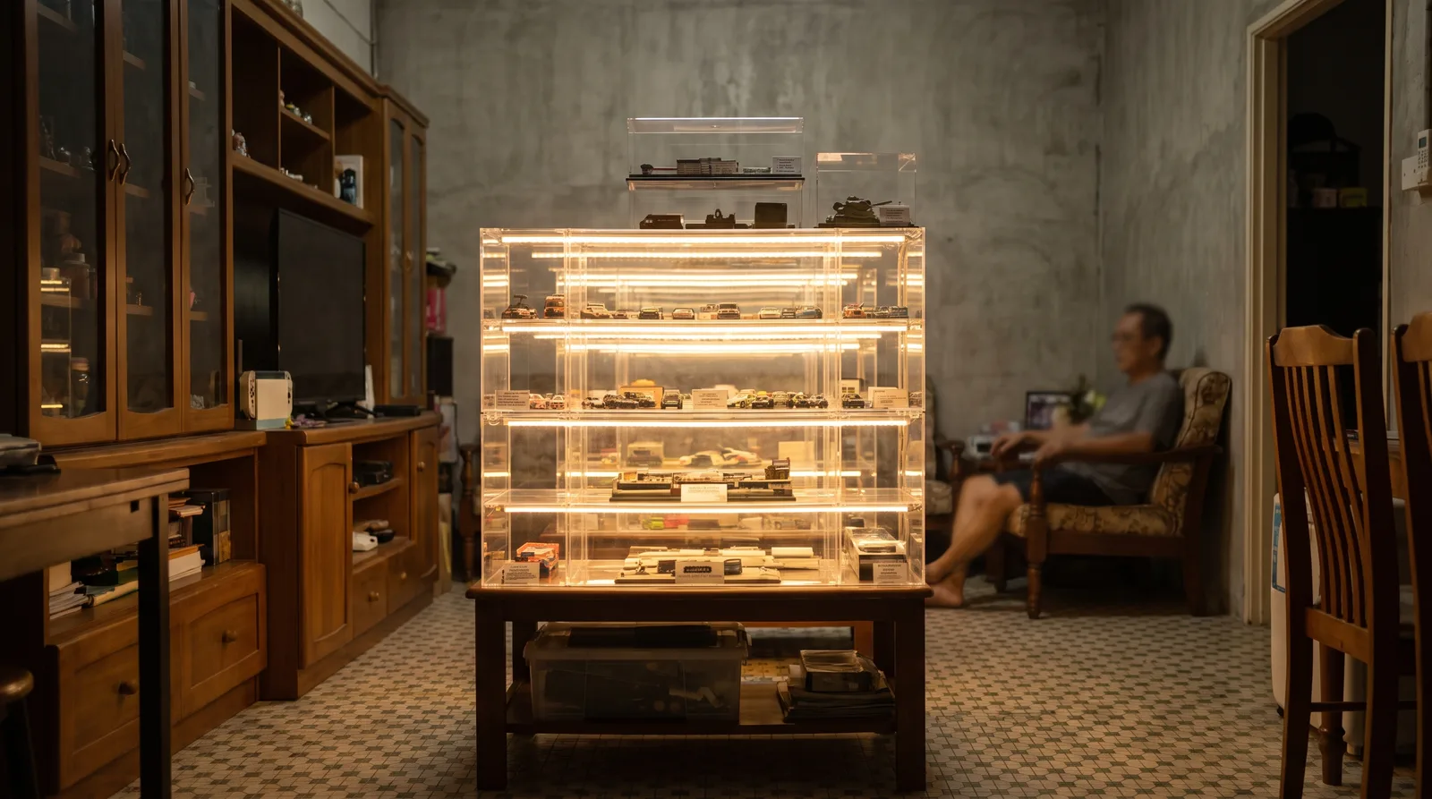LED-lit acrylic display case glowing in a dim room, light washing evenly across the shelves