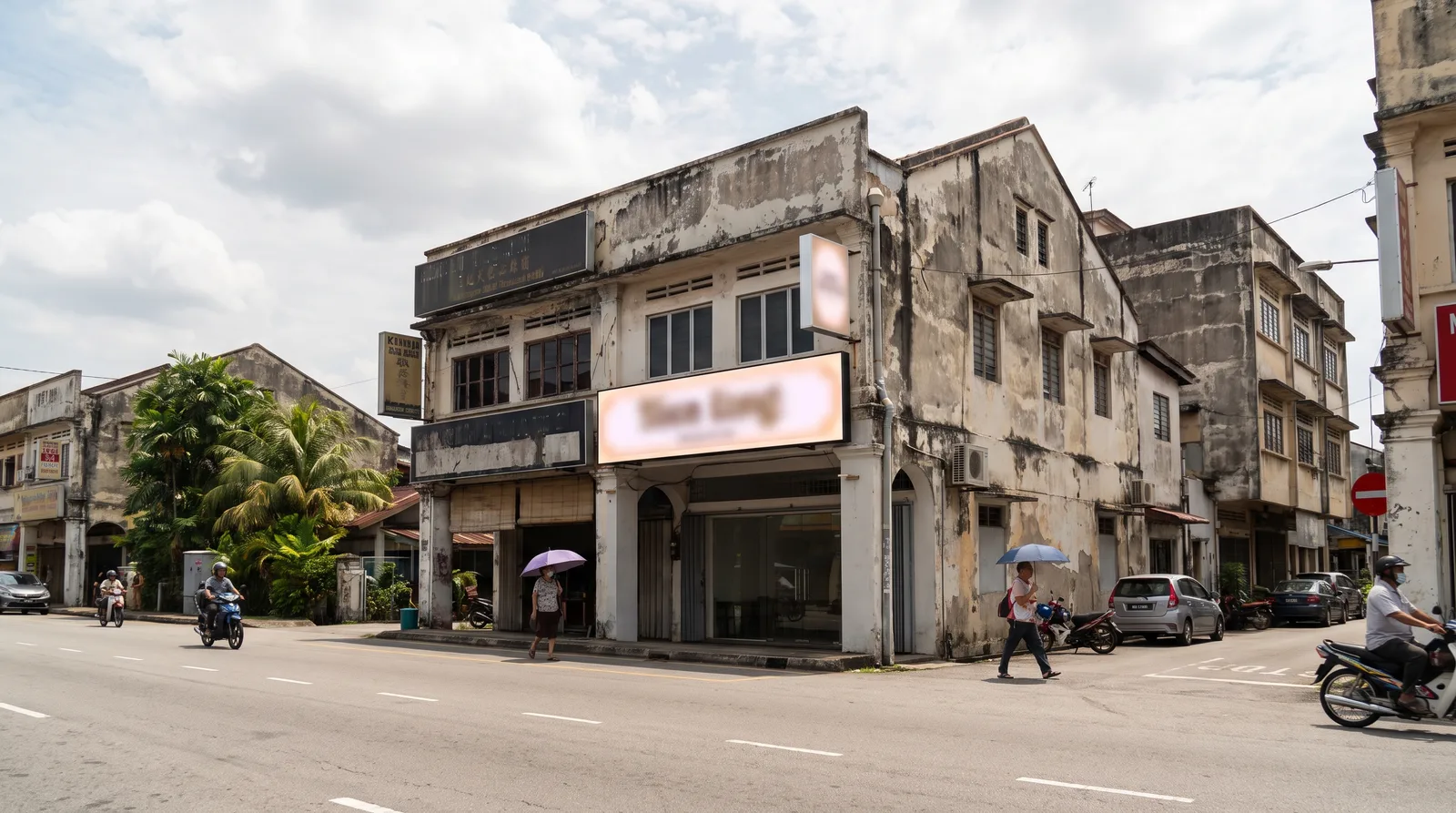 shopfront in a Malaysian town with a newly installed illuminated signboard, viewed from across the street