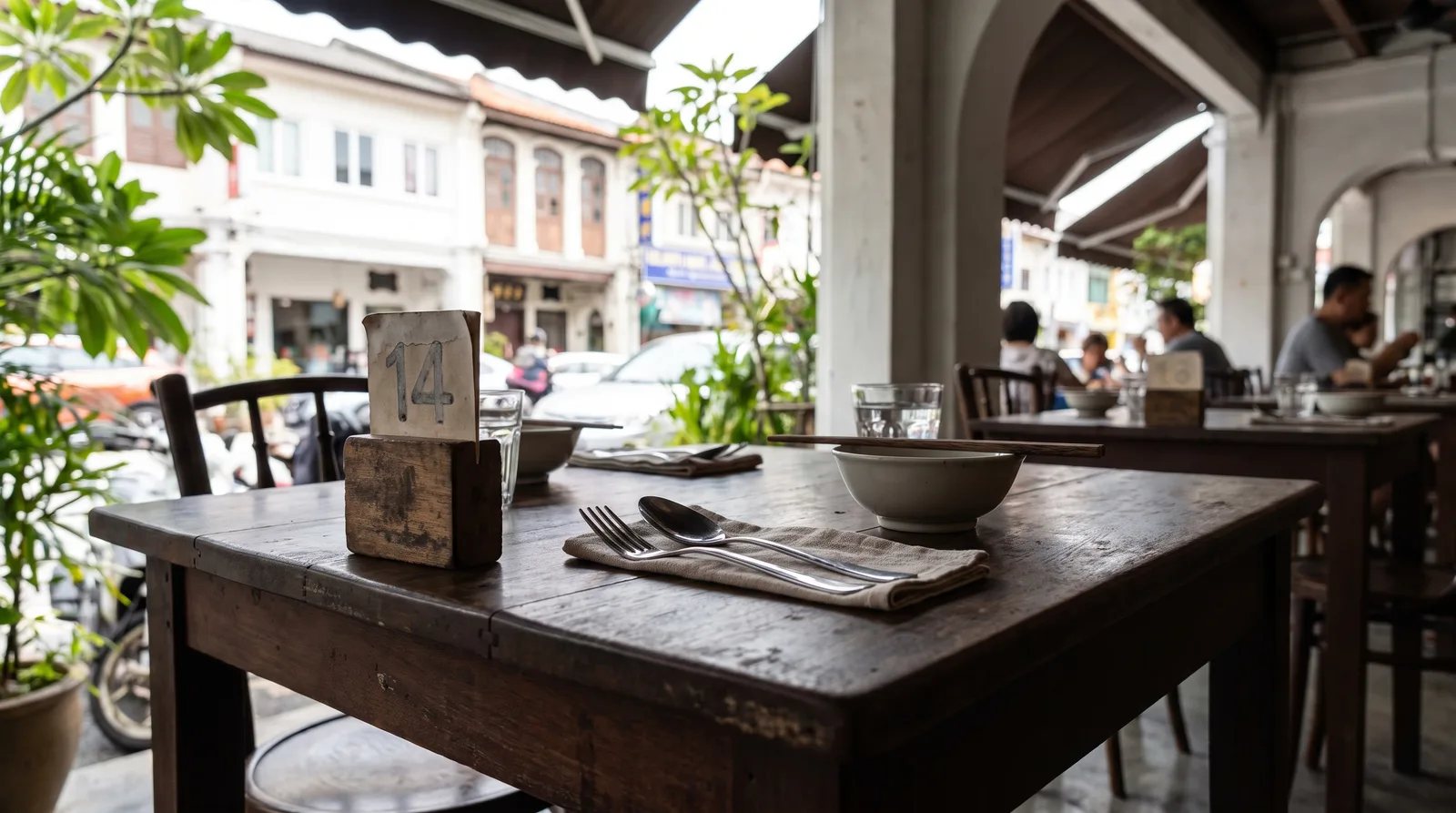 restaurant table set for service with a small standing table marker beside the cutlery