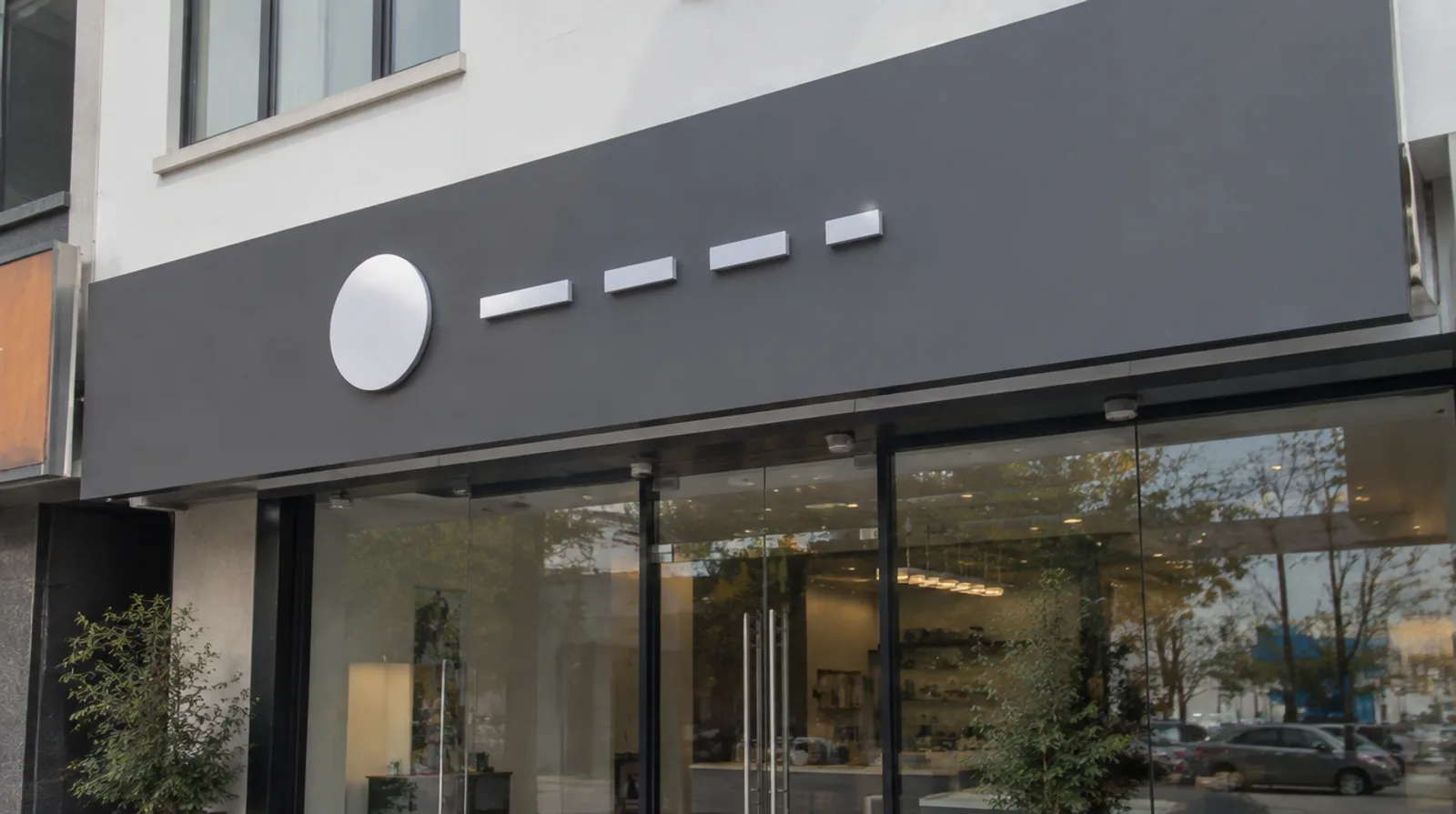 Flat dark grey aluminium composite panel shopfront signboard with raised white acrylic letters