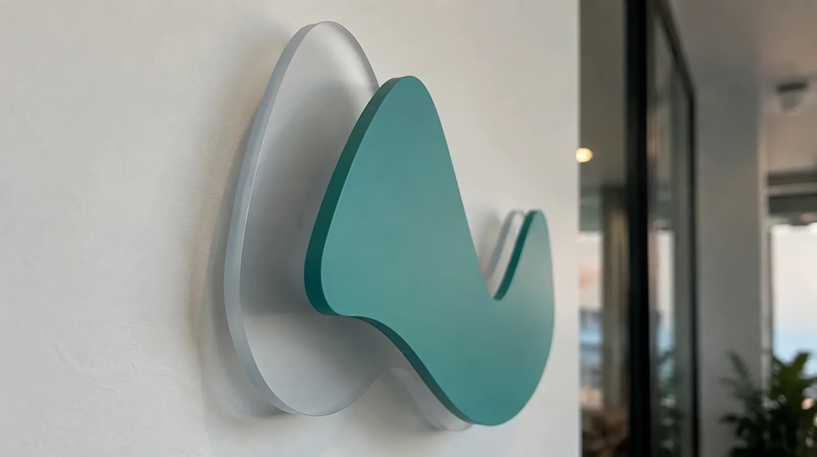 Layered acrylic logo sign with a frosted back panel and a raised coloured acrylic shape on top